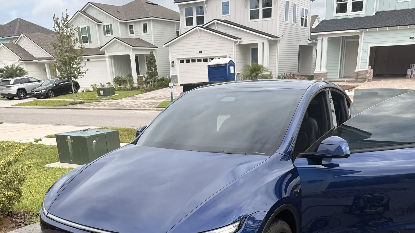 Freshly washed SUV with a deep, glossy shine parked in a neighborhood driveway